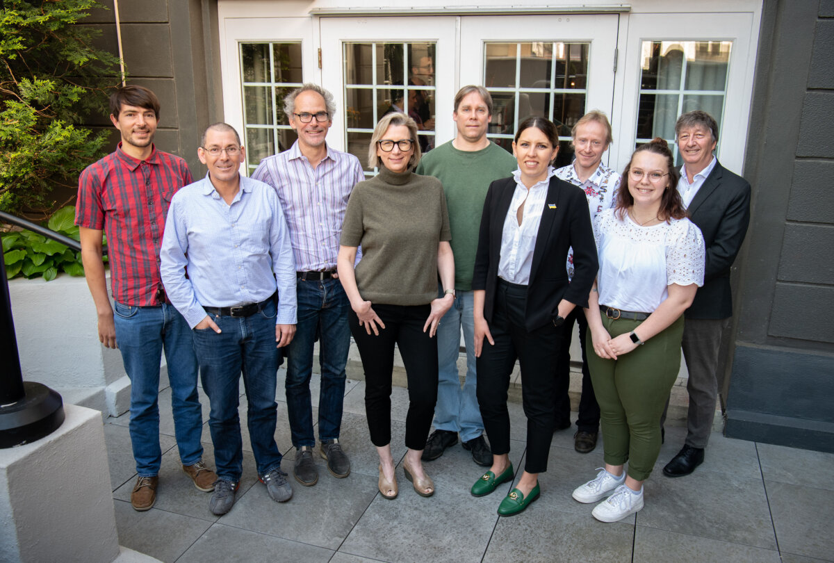 a group of people stand together outside of a building