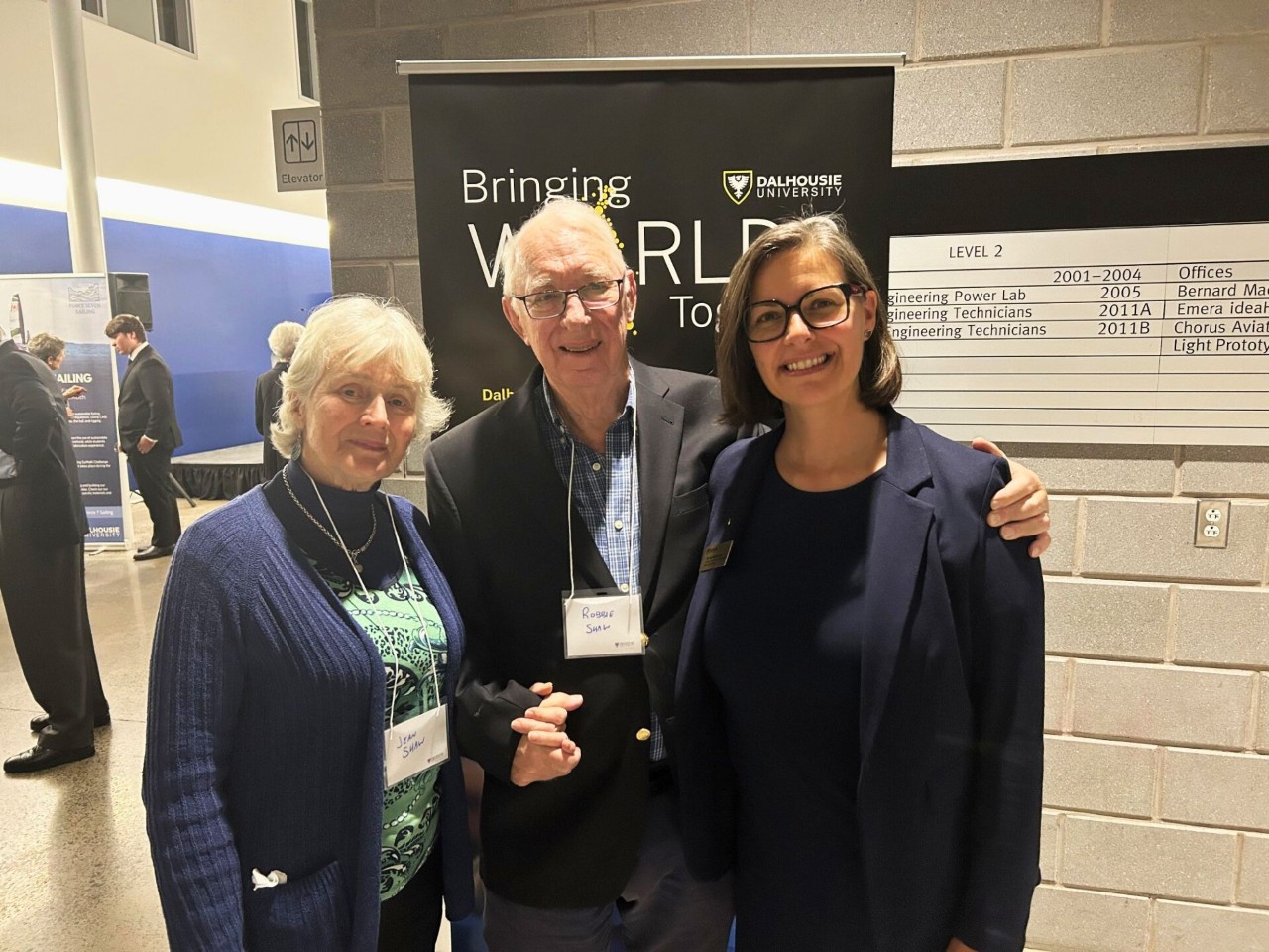 Laurette and the Shaws standing together, smiling at an event.