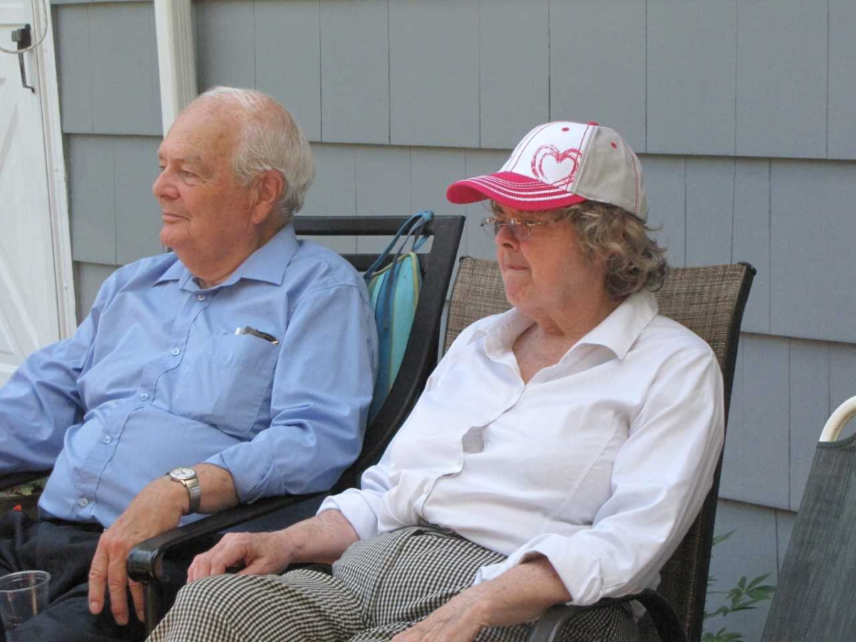 The Dauphinees are seated outdoors looking into the distance.