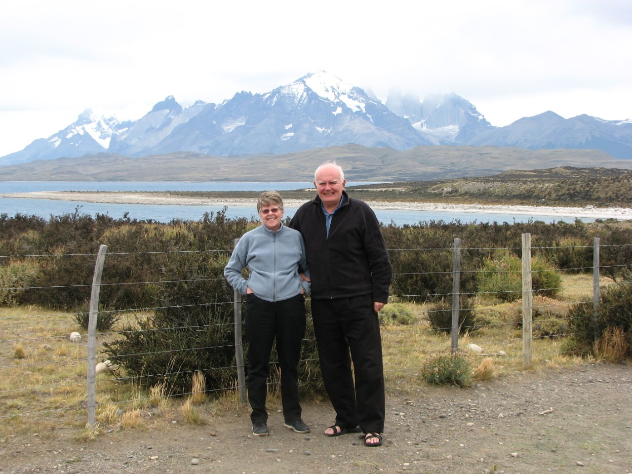 Jane and Arthur Sedgwick standing together with a snow-capped mountain range in the background.