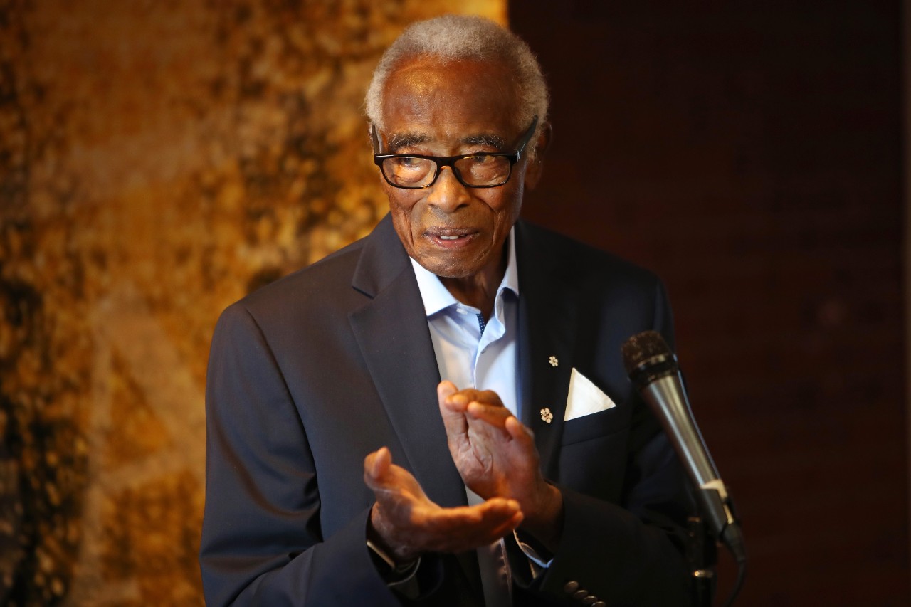 A man standing in front of a microphone clapping his hands