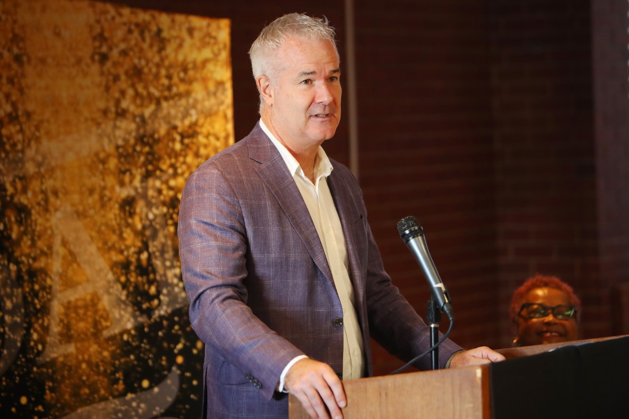 A man delivers remarks while standing at a podium