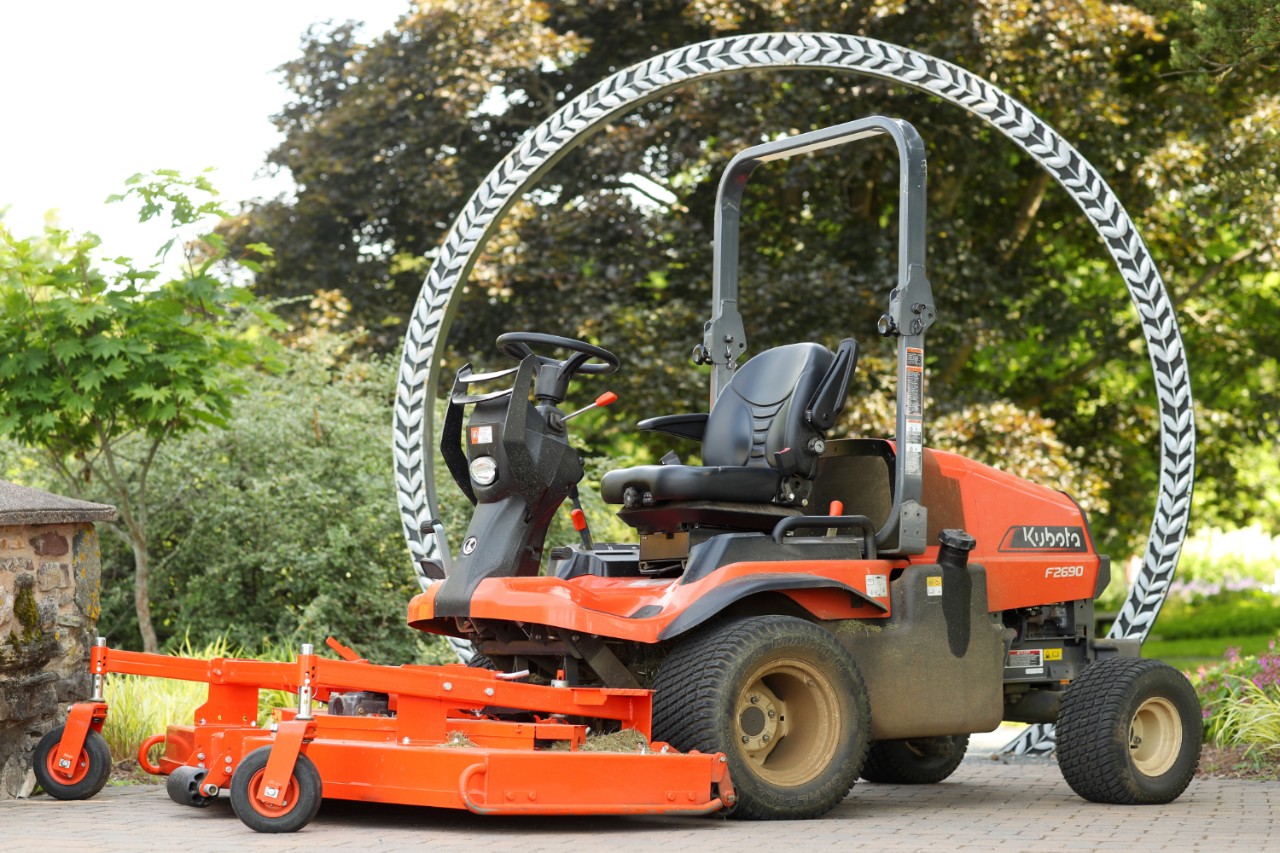 Grounds maintenance machine parked outside the entrance to a botanical garden.