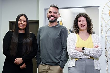 Dr. Shanté Blackmore, Dr. Brent Young and  Jordin Fletcher are standing together in a patient room. 