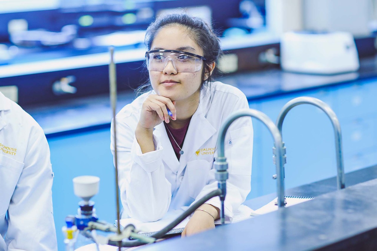 Student sitting at a desk in a lab.