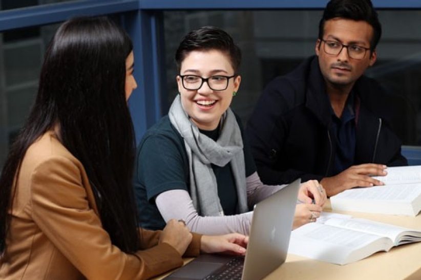 Three students study together.