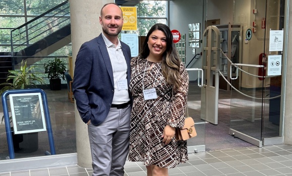 Patrick and Amanda Brousseau stand together in the law school.