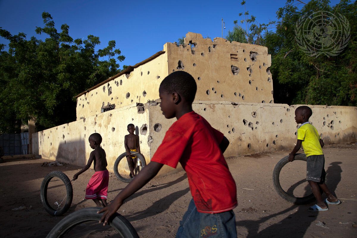 Children play next to a police station with bullet holes in Gao, Mali.