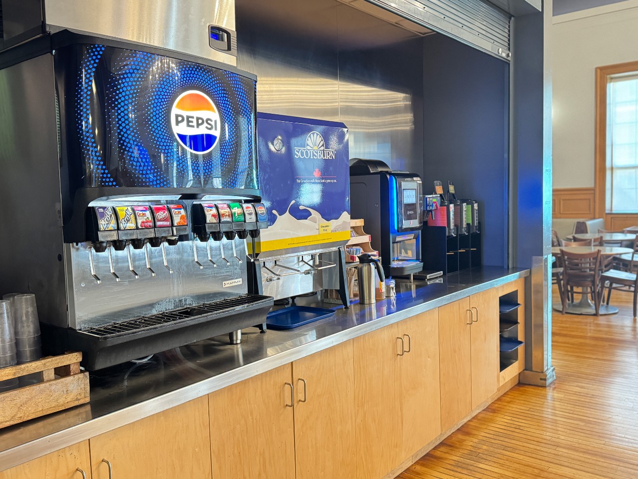The drink station features plenty of options including sodas, juices, milk, water, coffee, and tea