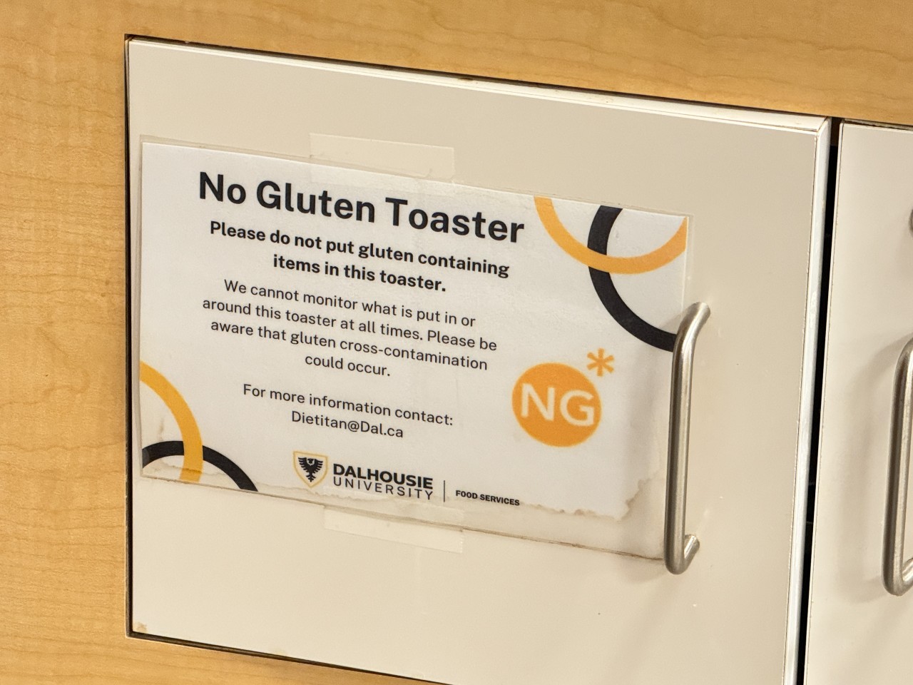 A sign on a small cupboard indicates it contains a special no gluten toaster