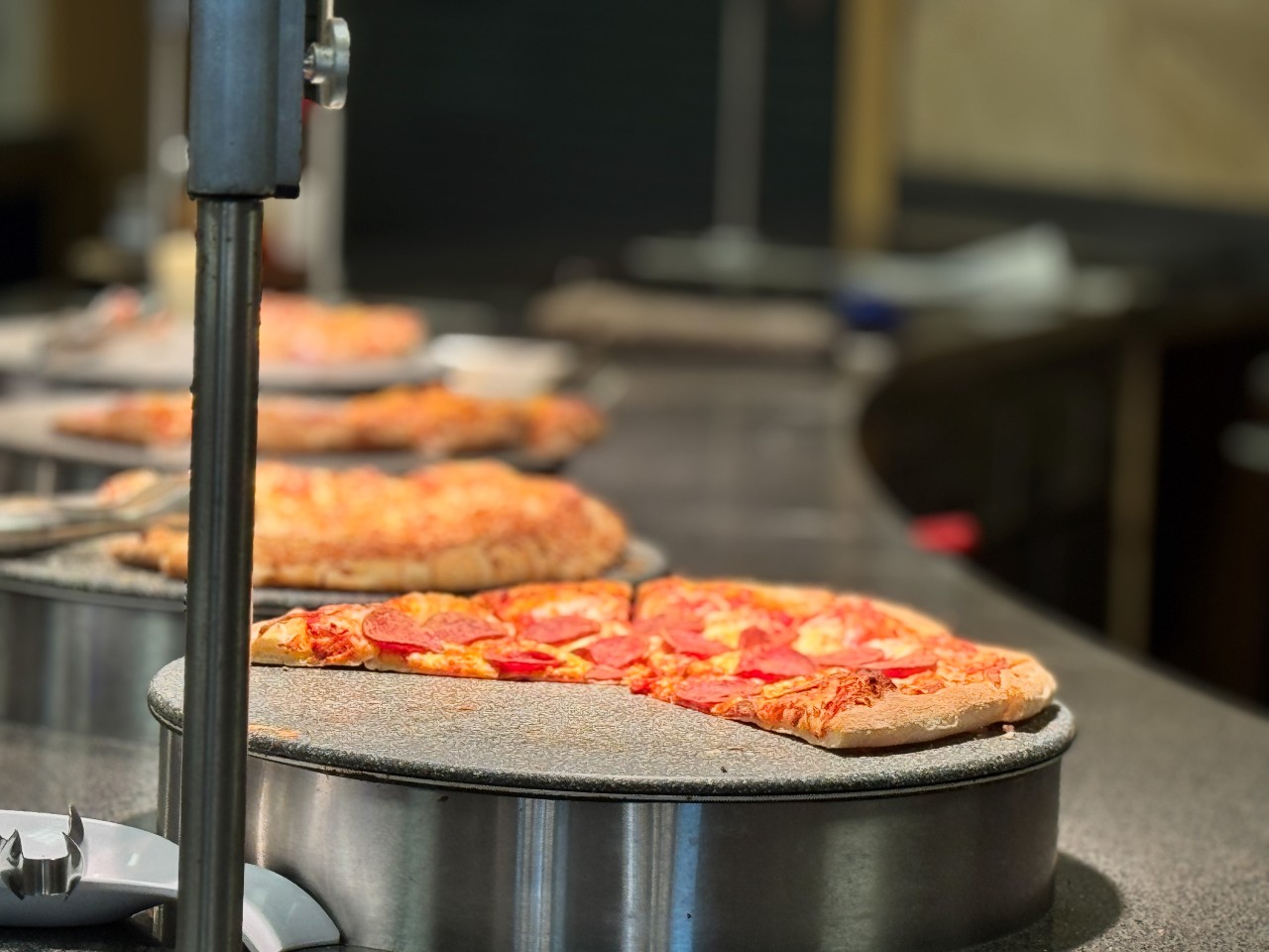 Pizzas of four different types sit ready to serve students 