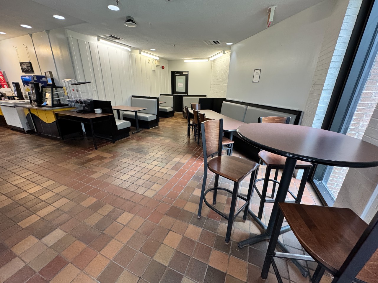 The back corner of the seating area is cozy, with a combination of booths and tall tables