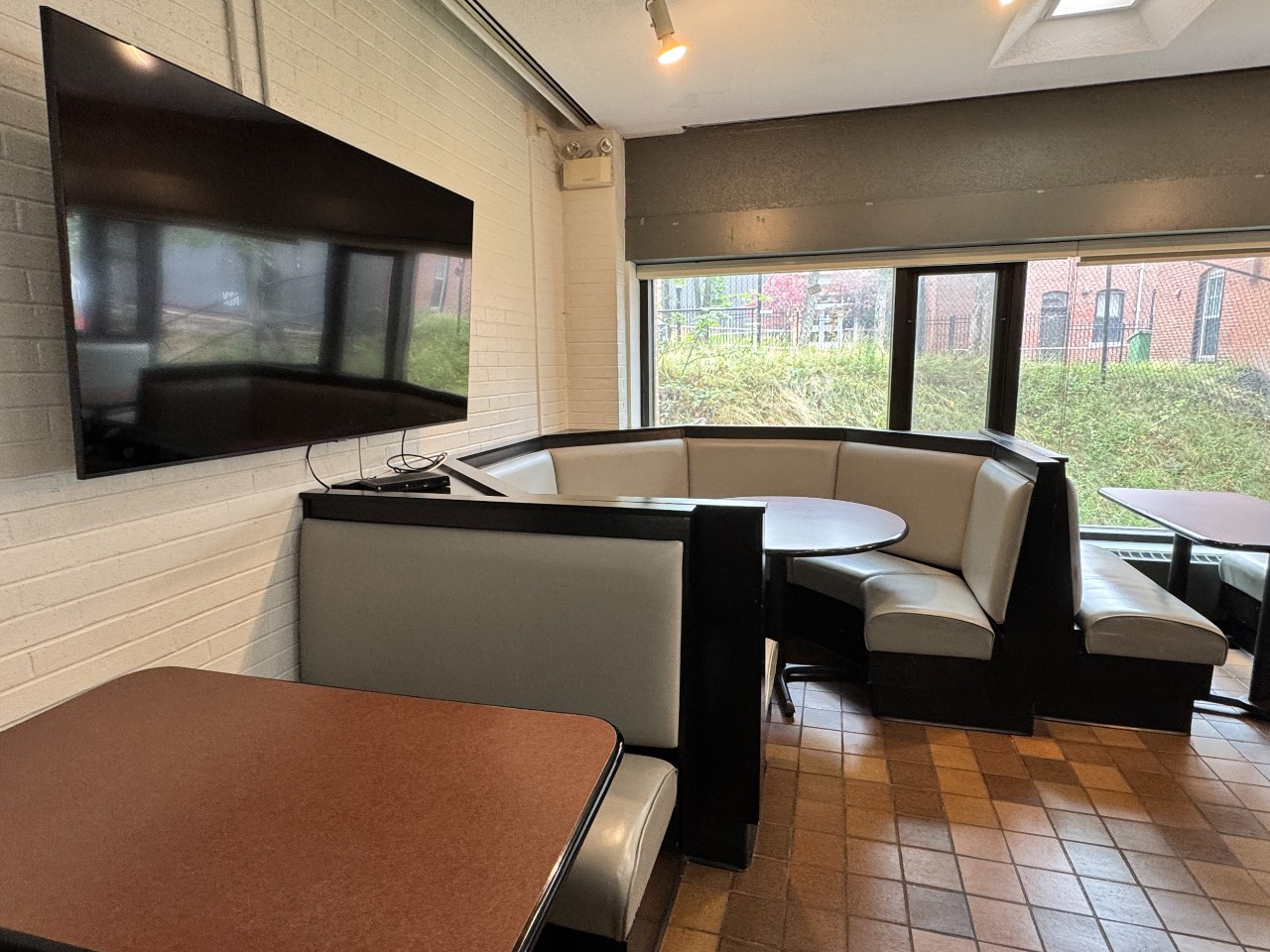 A found booth in the corner is perfect for a group. It sits next to a large television on the wall