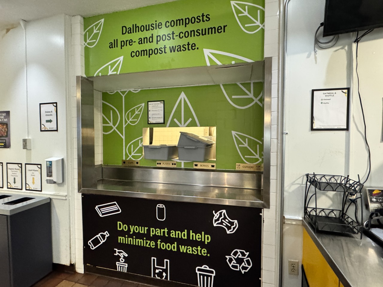 The dish return has bins for waste and a conveyer belt for dishes