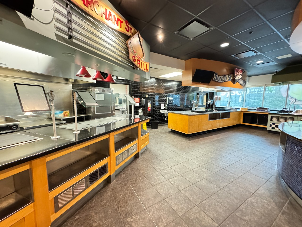 The servery has multiple stations for serving hot dishes
