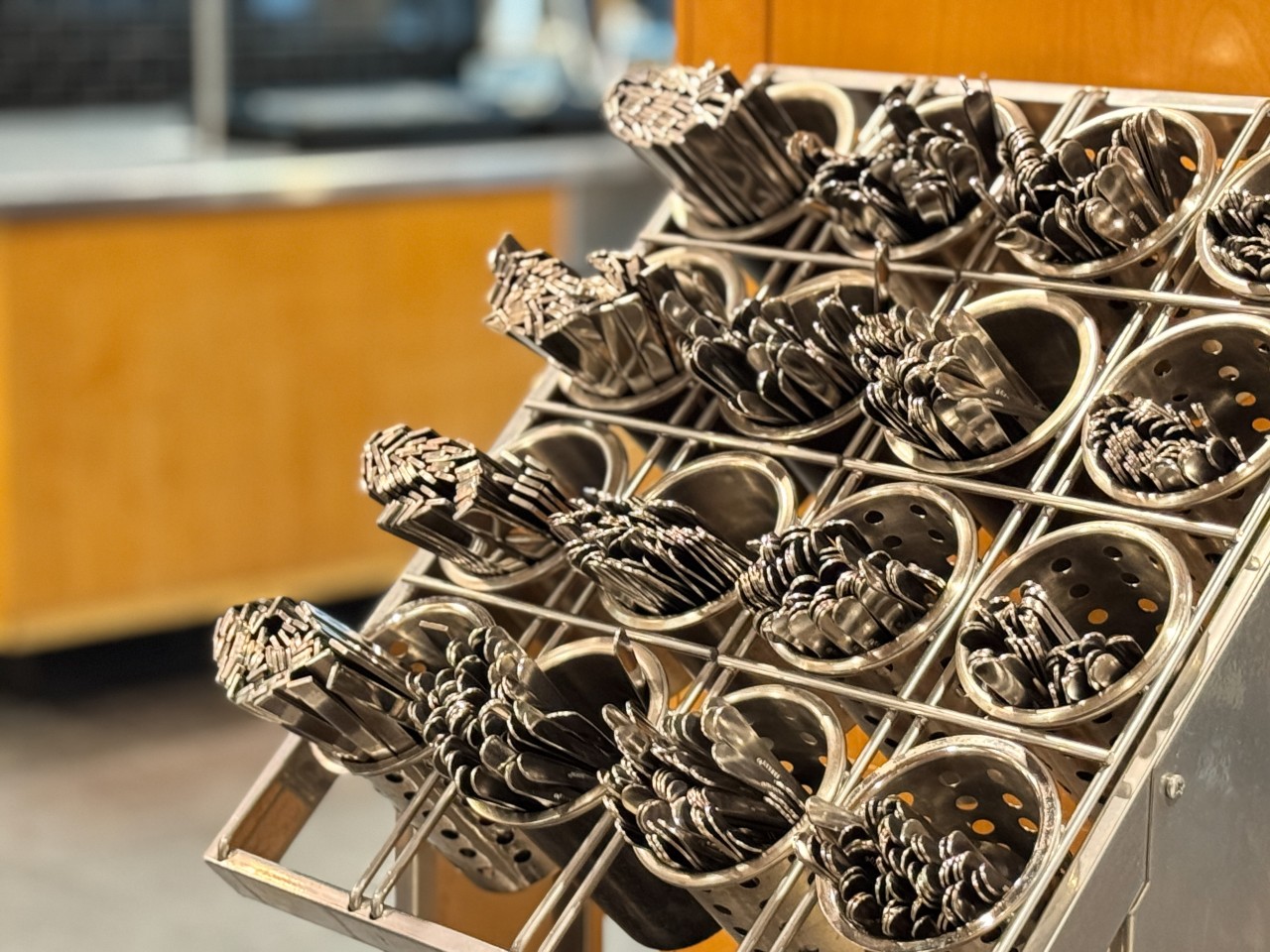 Plenty of clean cutlery is in the stand near the entrance to the servery