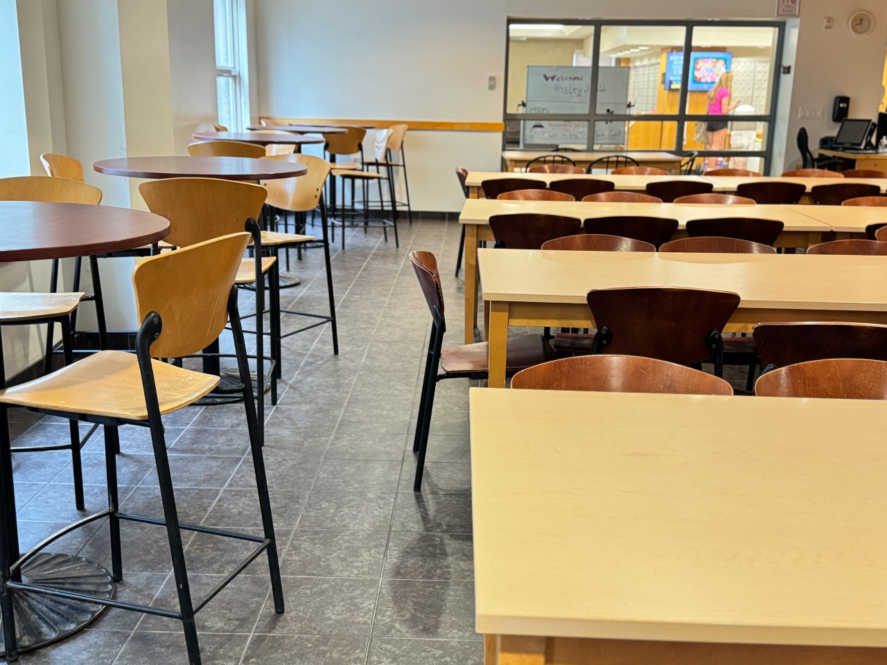 The seating area has a mix of long tables and tall round tables with plenty of chairs