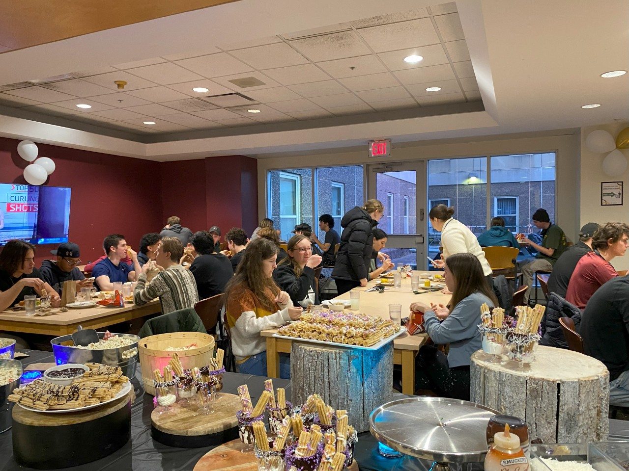 Students enjoy a themed event at Risley dining hall, with plenty of unique themed food on serving stands