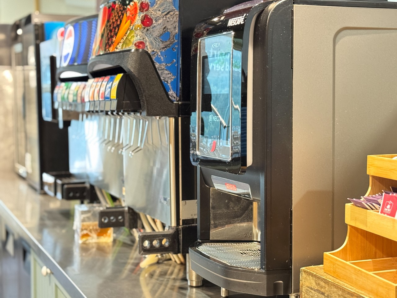 The drink counter features sodas, juice, milk, water, tea, and gourmet coffee options