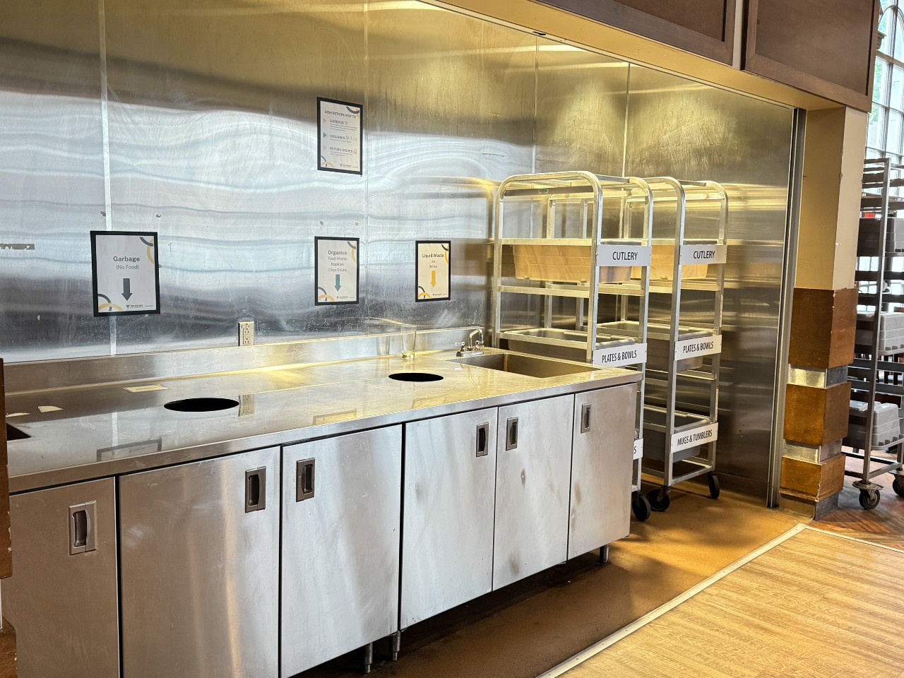 The dish return has bins for disposing of different types of waste and basins for depositing dishes