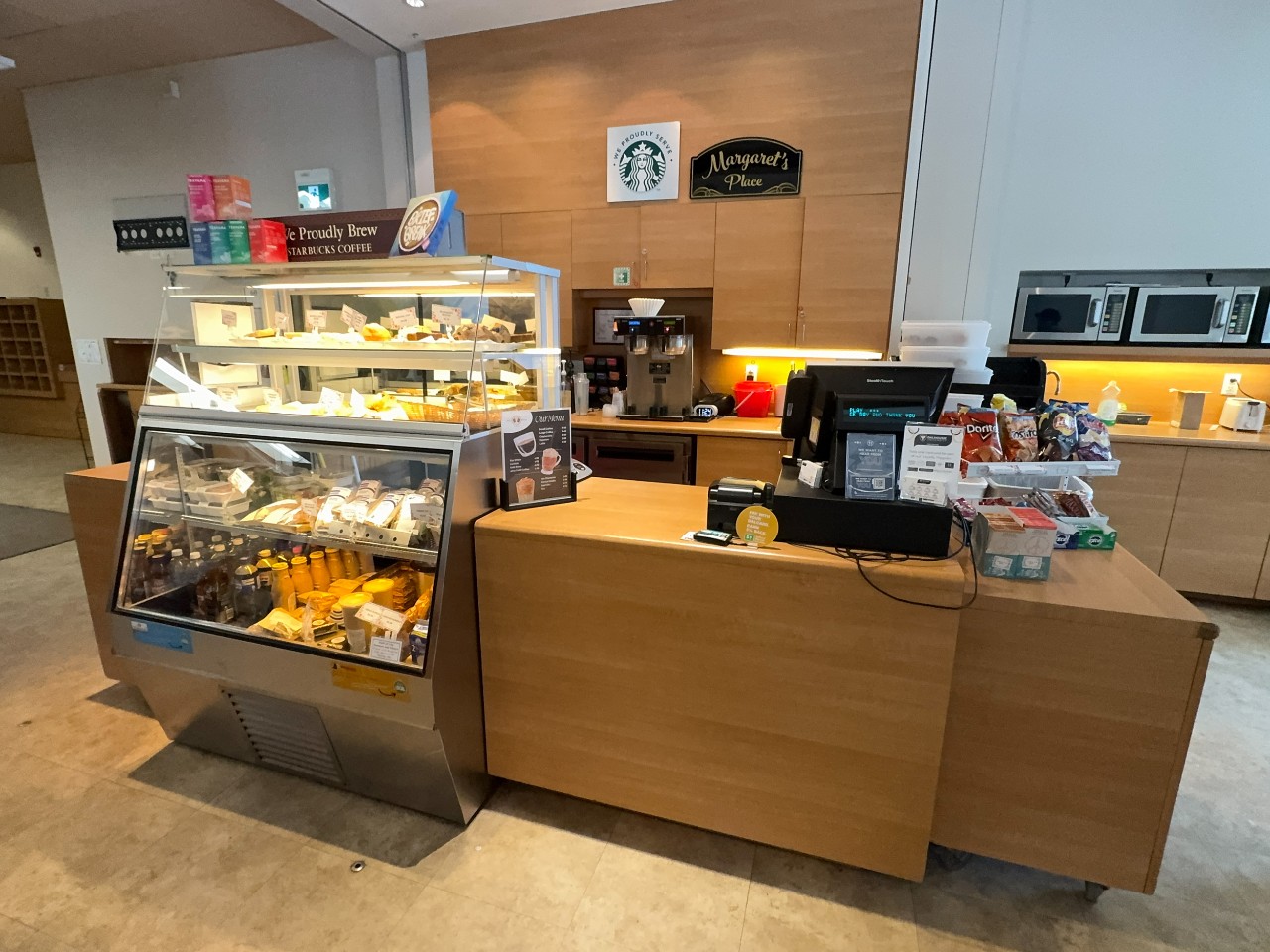 The Brief Break Café has a glass case of food and juices, and coffee prep area behind the counter