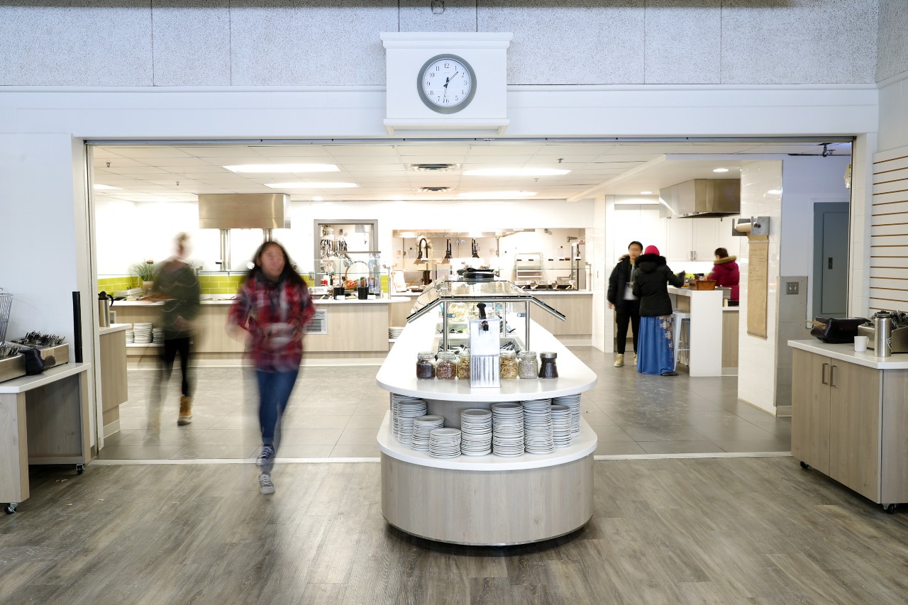 The salad bar sits in the middle of the serving area as students pass by on both sides