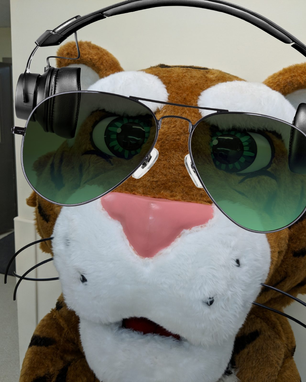 The Dal Tiger poses for a photo wearing headphones and sunglasses