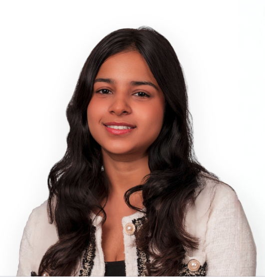 A portrait of Rabjot wearing a dark top and a white cardigan with a pattern on the front.