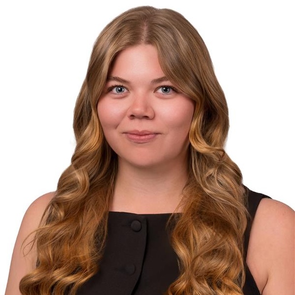 A portrait of Jessica Durham wearing a sleeveless black top in front of a white background.