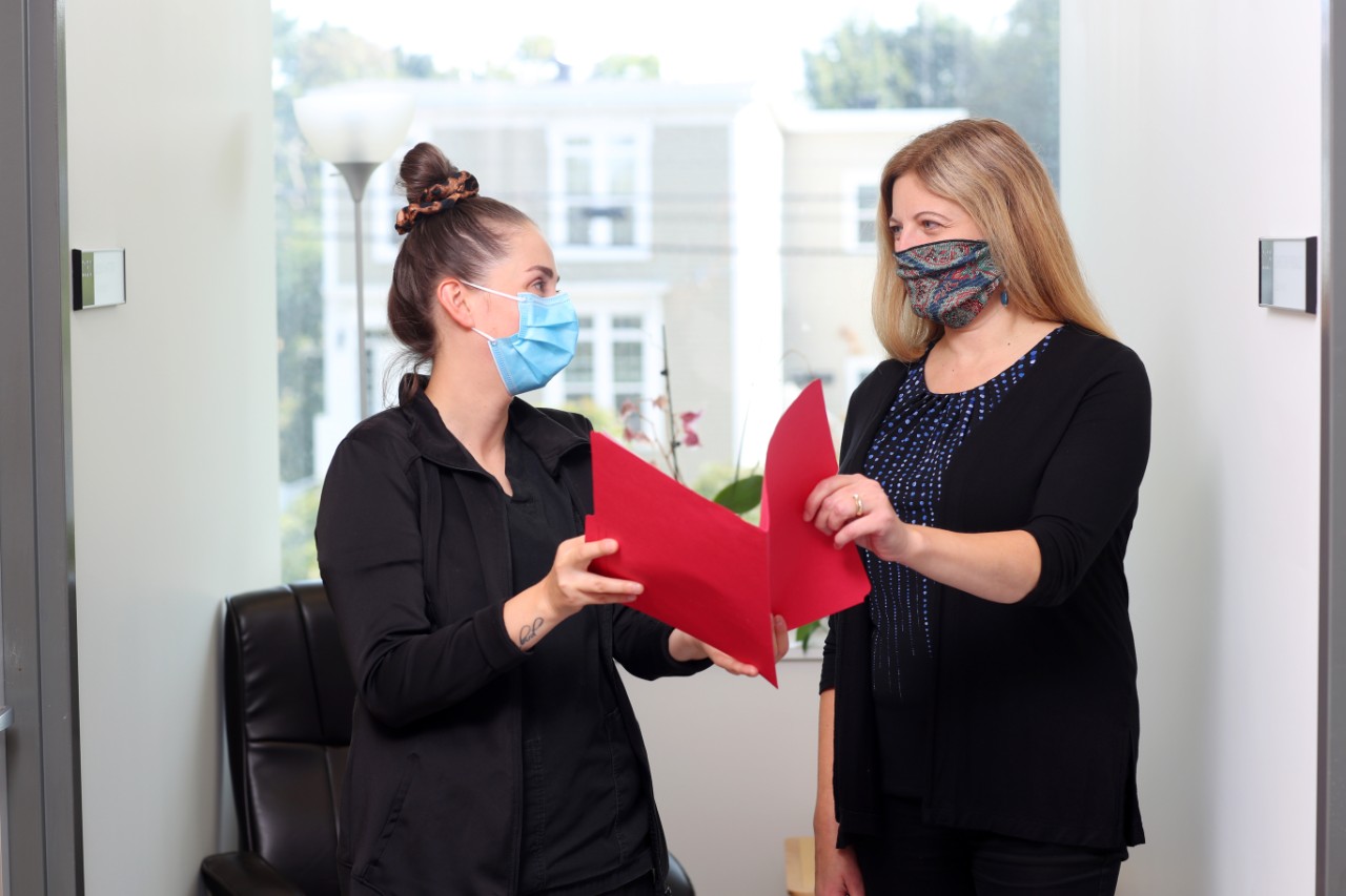 Counsellor and nurse looking at file together