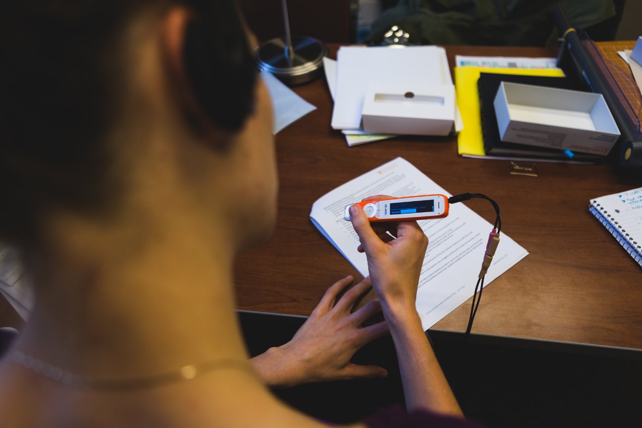 Student using assistive technology on a piece of paper