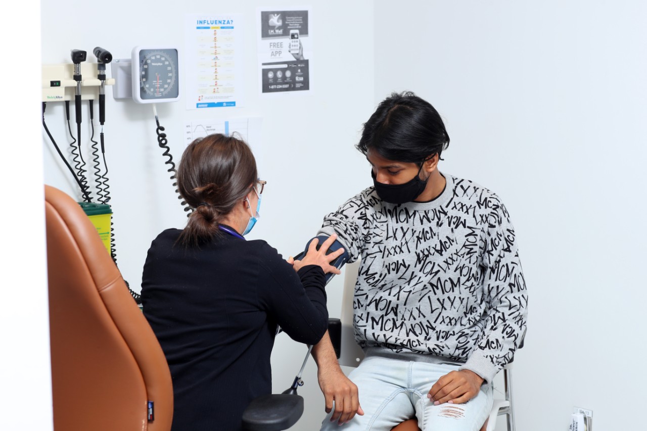 Student getting their blood pressure checked by a nurse
