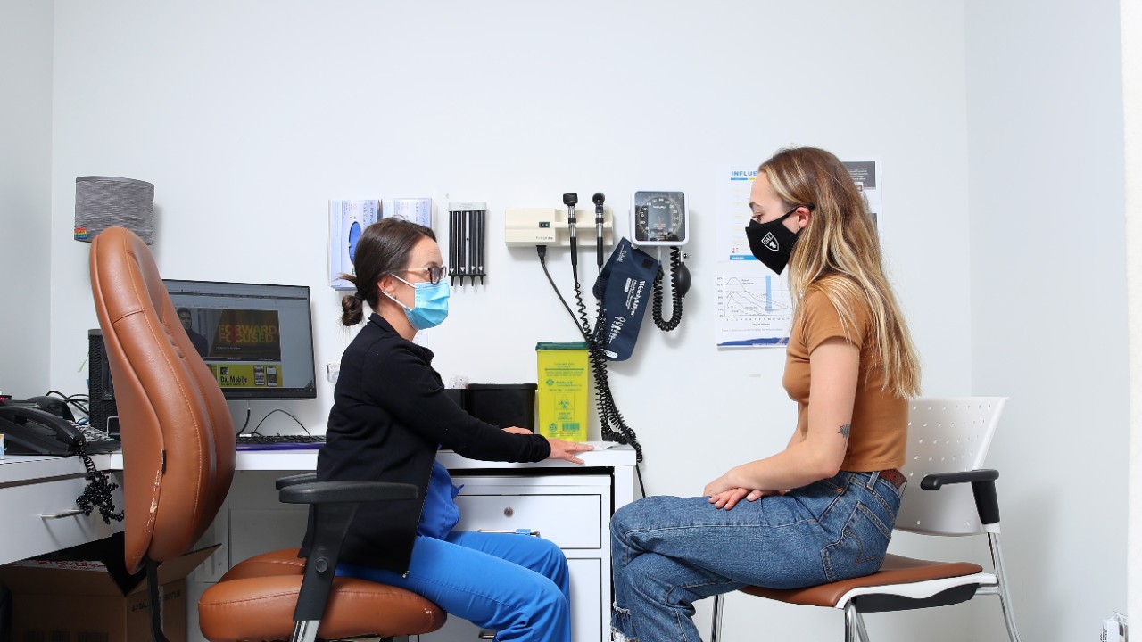 Student talking with a nurse at the health clinic