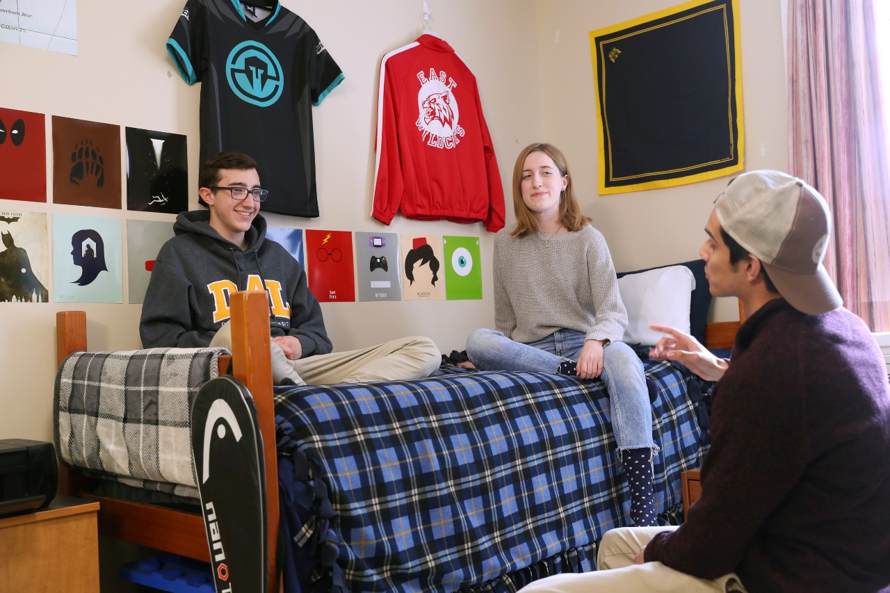 Three residents hang out in a room in Shirreff Hall