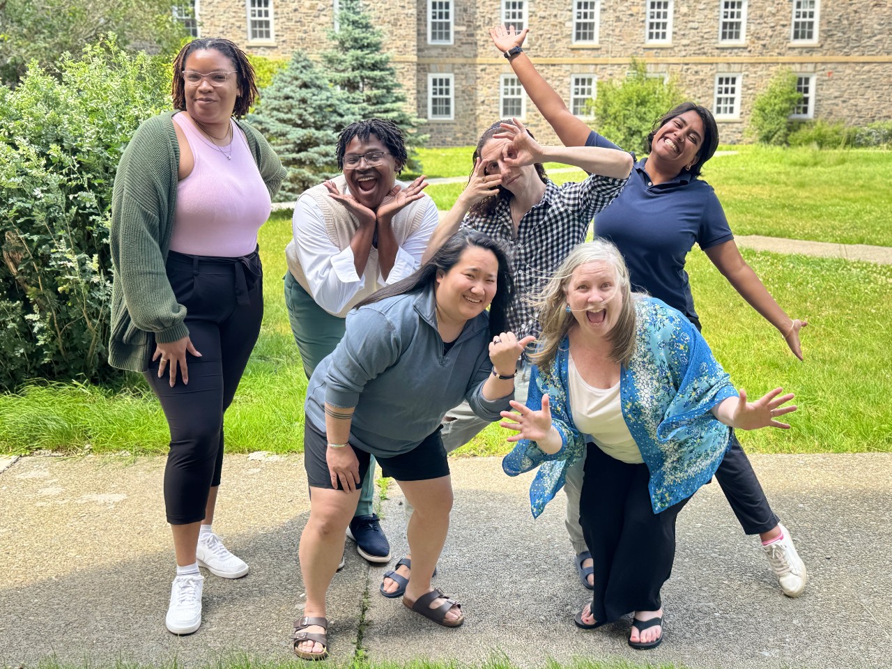 The residence life team for the Halifax campus strikes a variety of silly poses for the camera. 