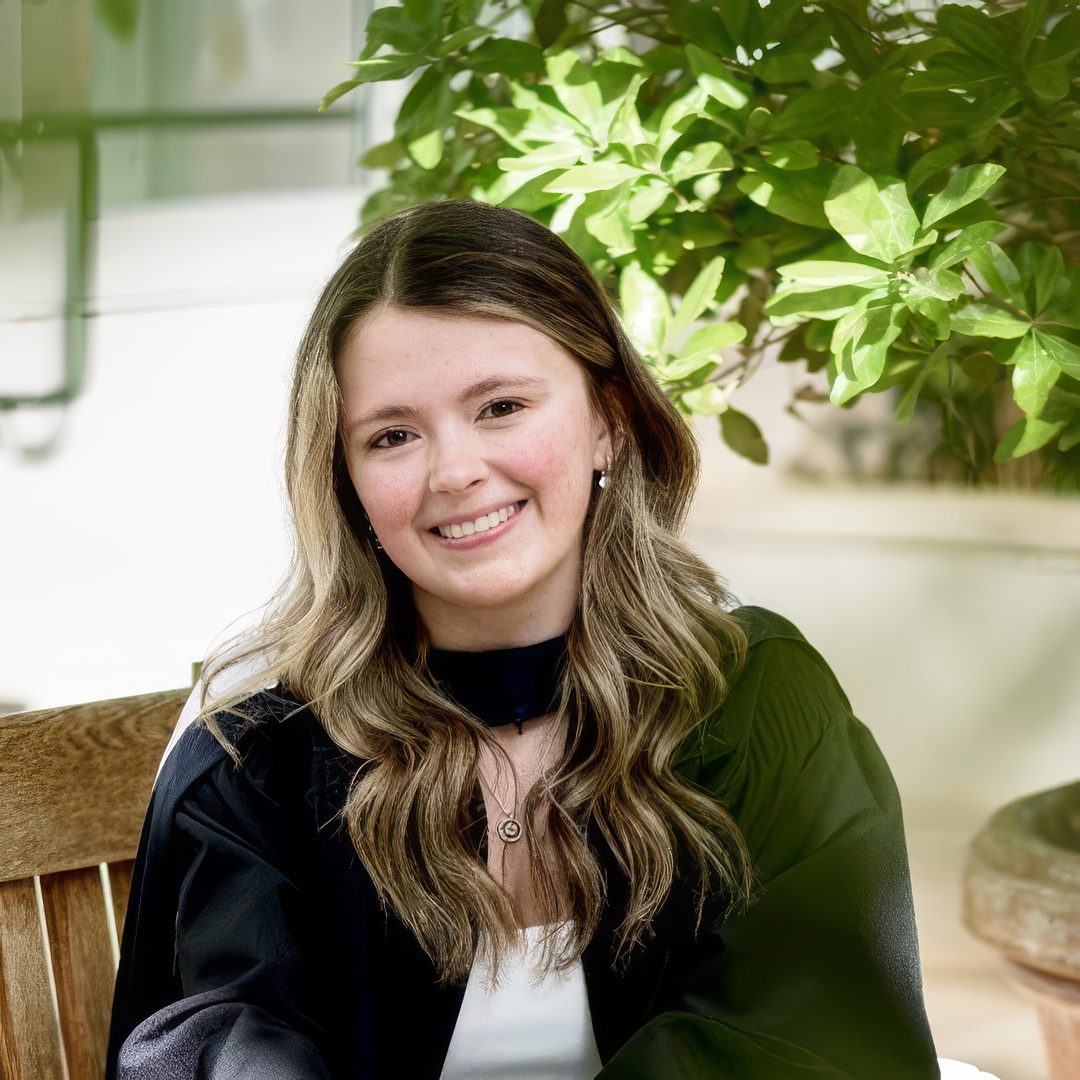 A photo of Jenna Decaire, a young woman with long wavy light brown hair dressed in black