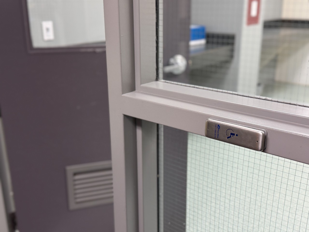 The automatic door button in a hallway in Risley Hall