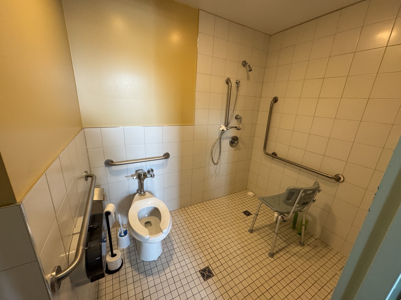 The bathroom in an accessible room in Risley Hall, with grab bars and a roll-in shower