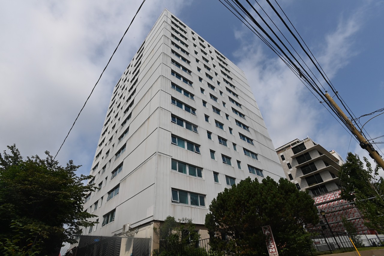 The corner of Peter Green Hall, looking upward, showing the tall apartment building that offers family housing for Dalhousie students. 