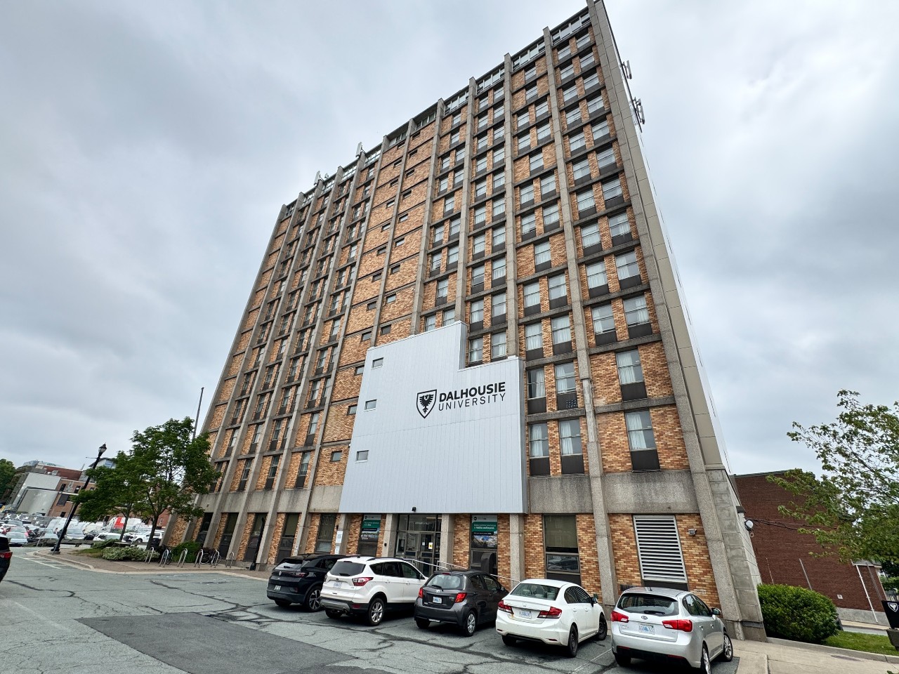 Exterior photo of Gerard Hall, showing the main entrance, bicycle racks, and looking upward toward the top of the building. 