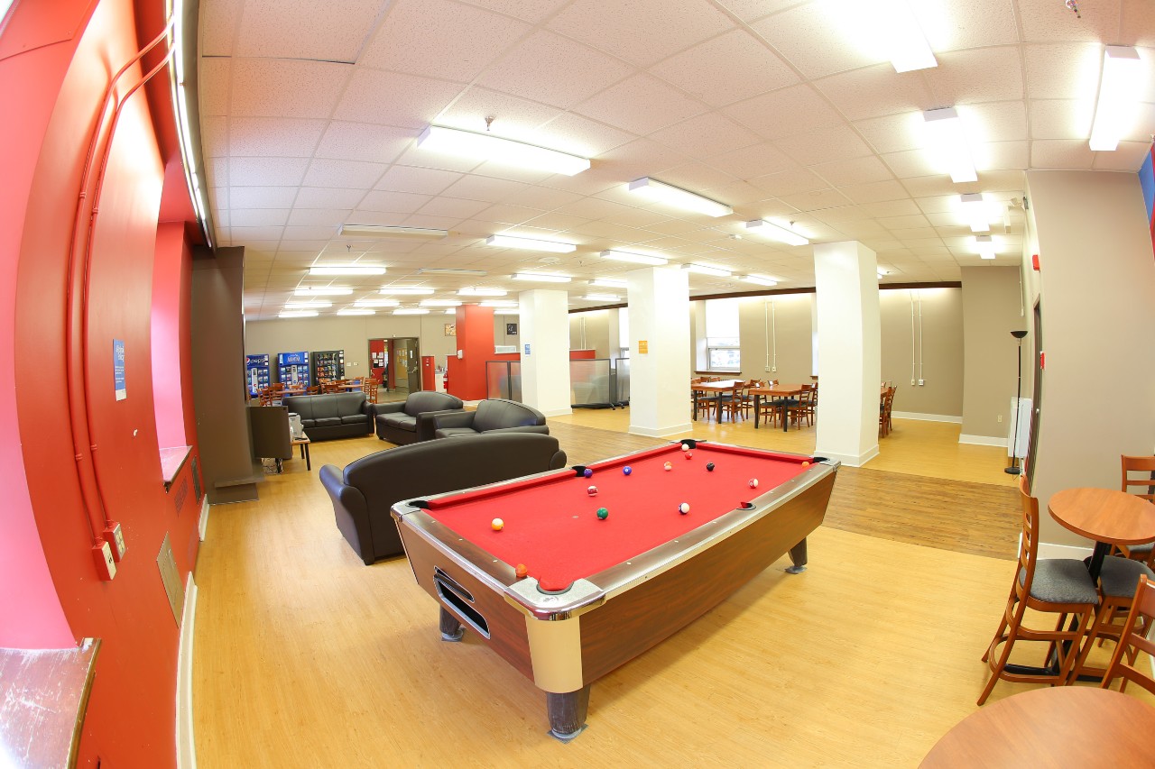 The main floor lounge in Gerard Hall featuring a pool table covered in red felt