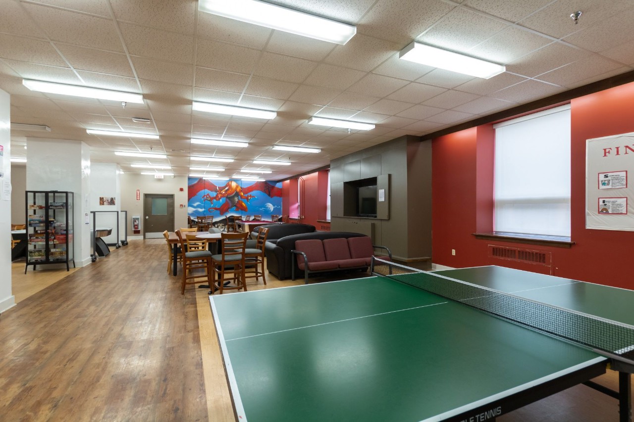 The ping pong table in the main floor lounge at Gerard Hall. In the background is the dragon wall mural.