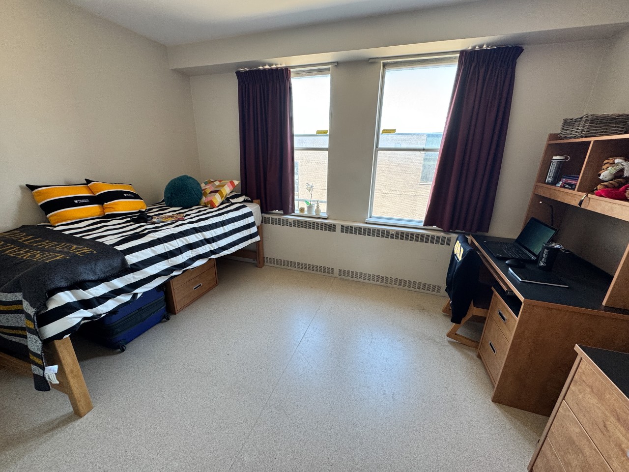 A spacious super single room in Gerard Hall, with large windows and furnishings