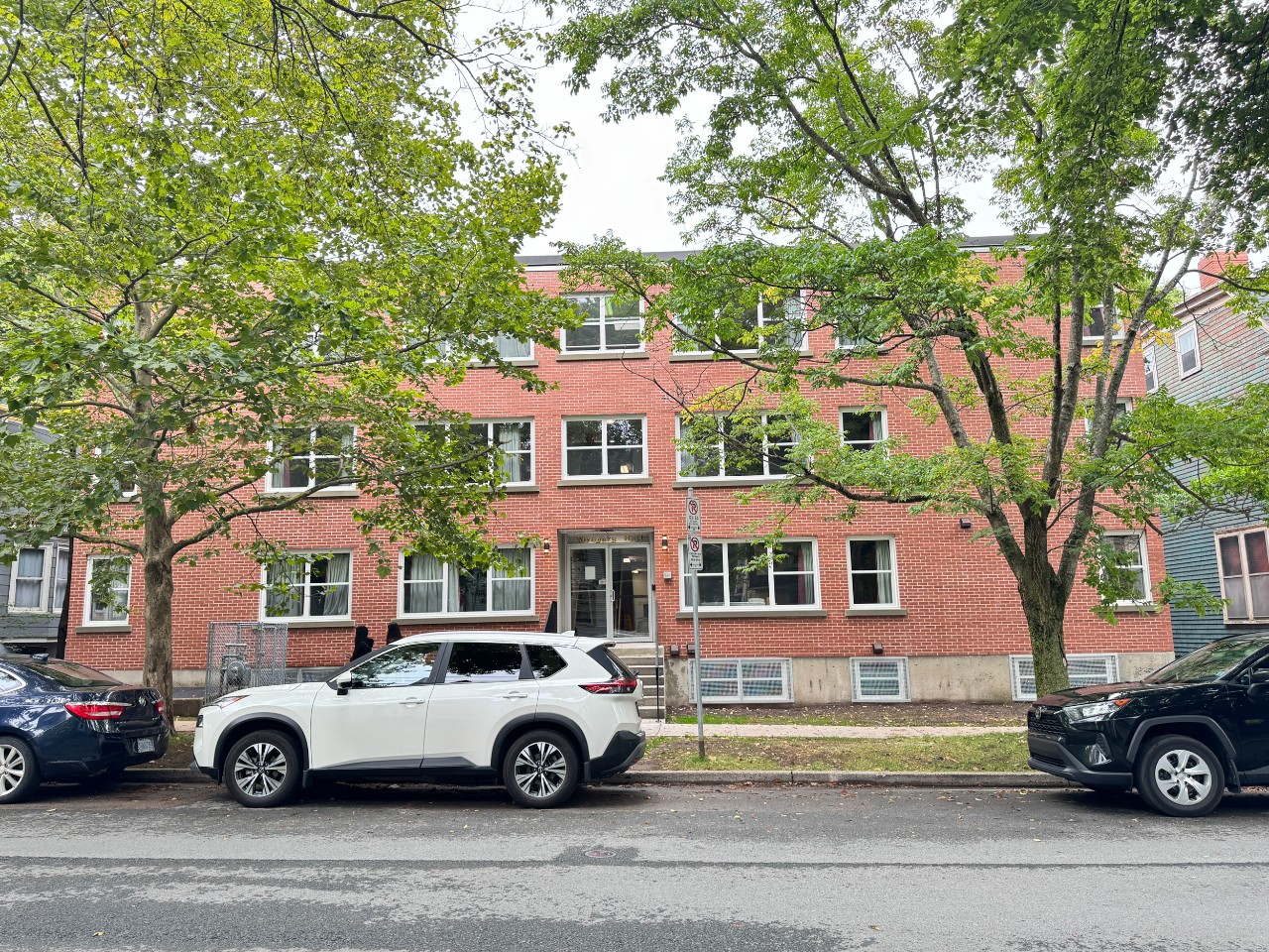 The newly-renovated front of Glengary Apartments, covered in red brick