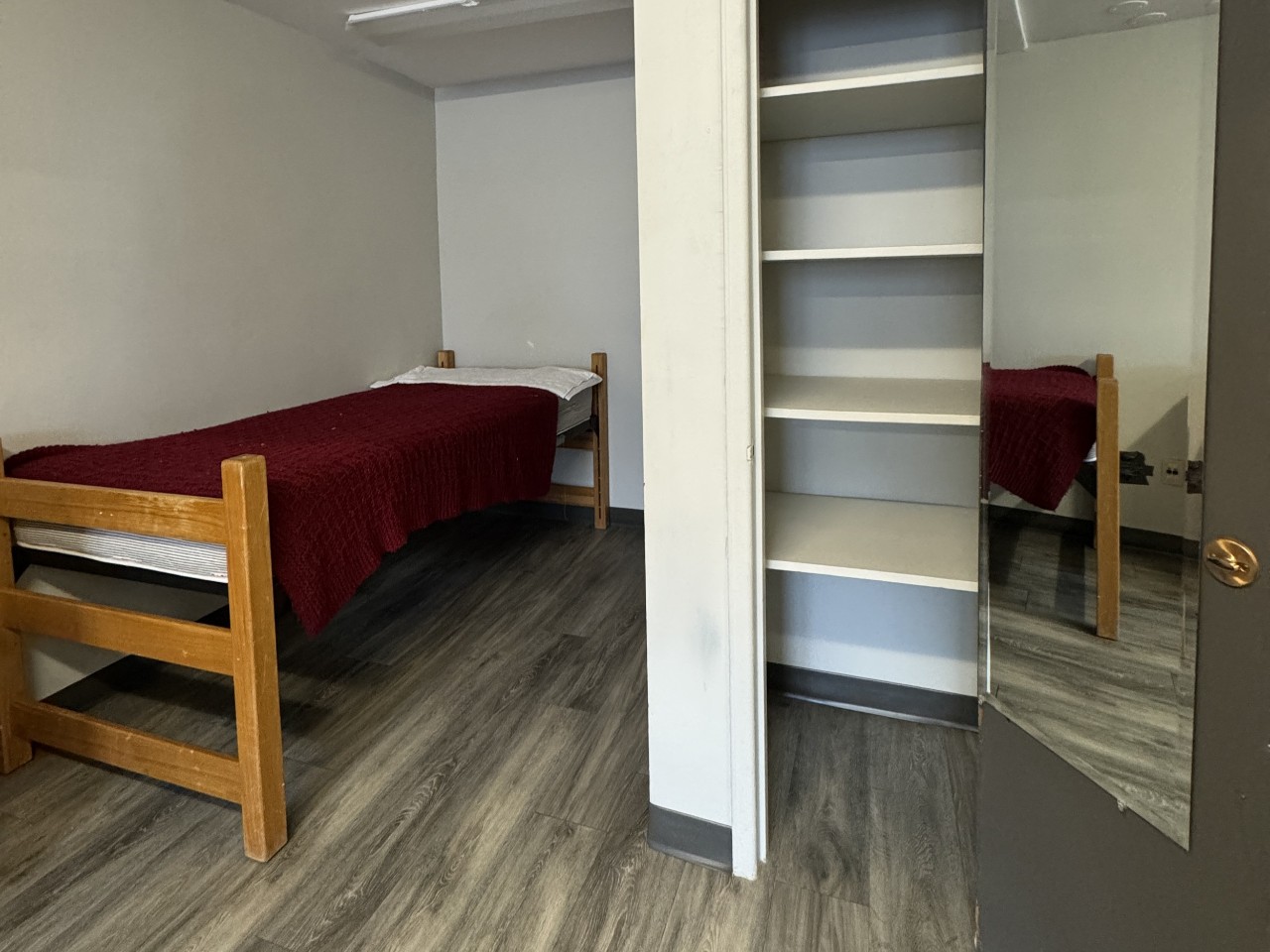 The bed and built-in closet in a bachelor apartment in Glengary