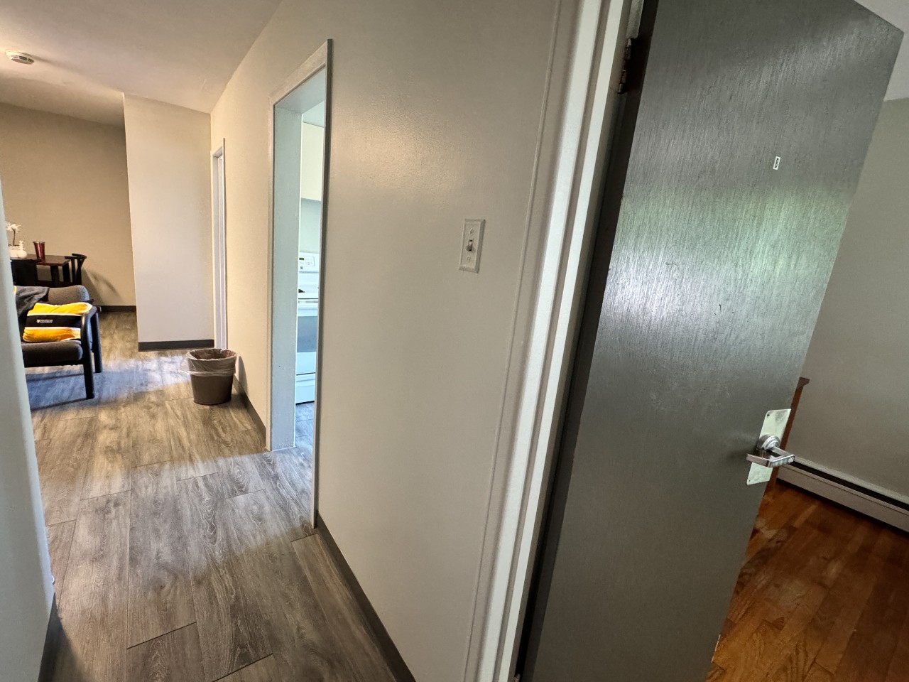 The hallway of a 3-bedroom apartment in Glengary opens into the kitchen, bathroom, and 2 bedrooms