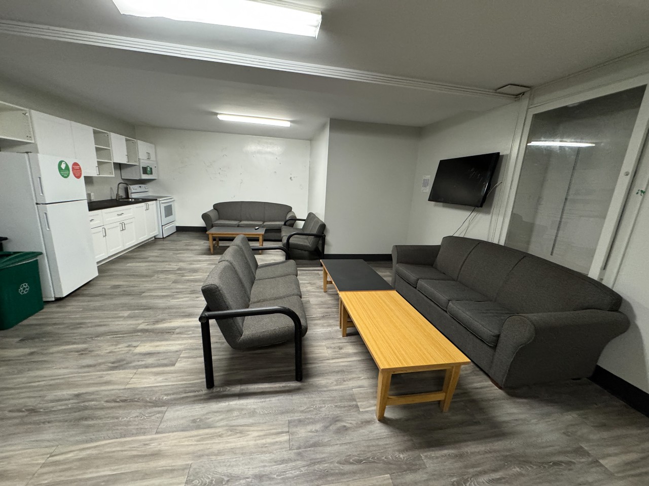 A wide photo of a large lounge in Bronson House with a full kitchen and plenty of seating