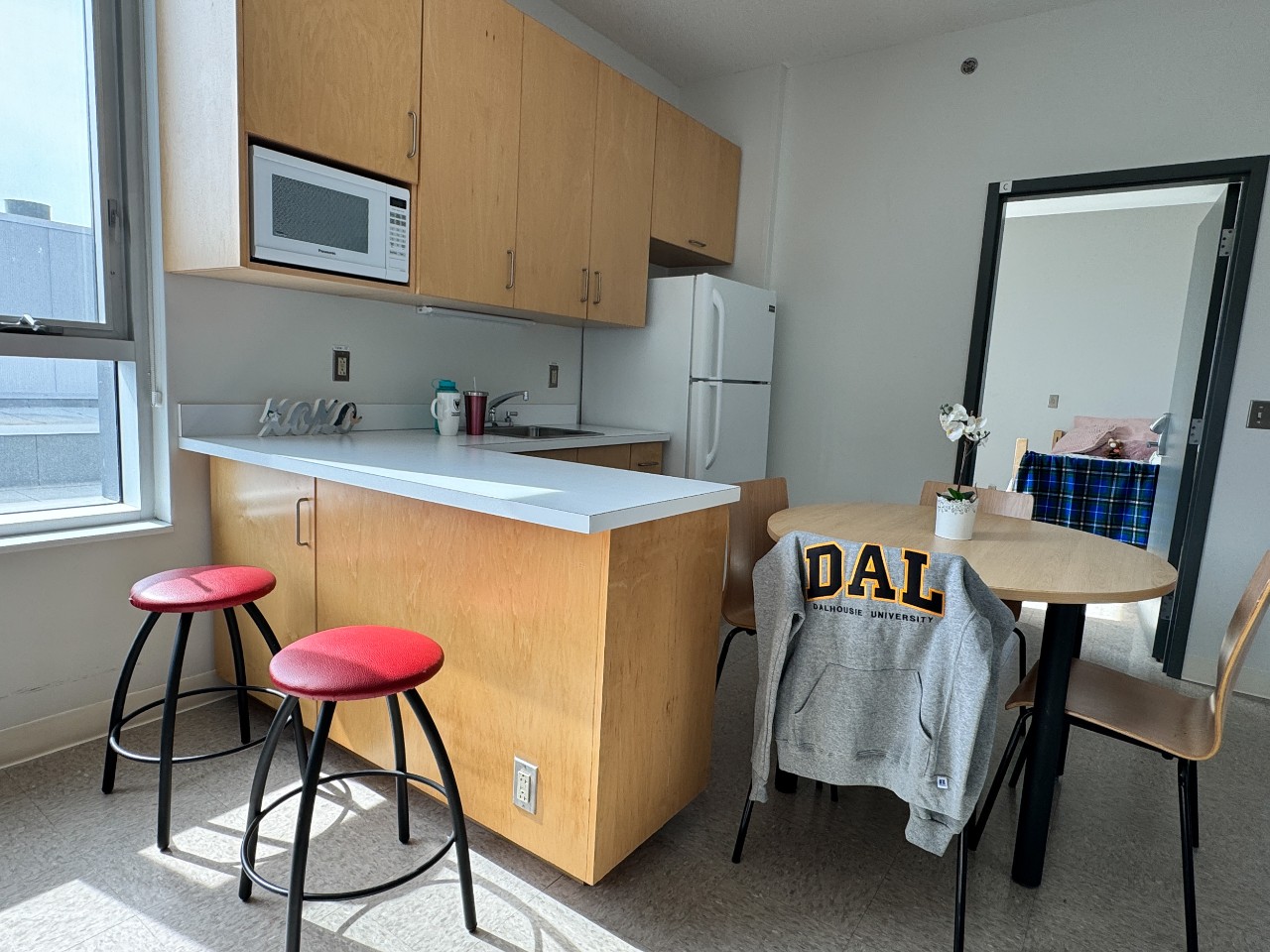 The kitchen in a 4-bedroom suite in LeMarchant Place with barstools next to the kitchen island
