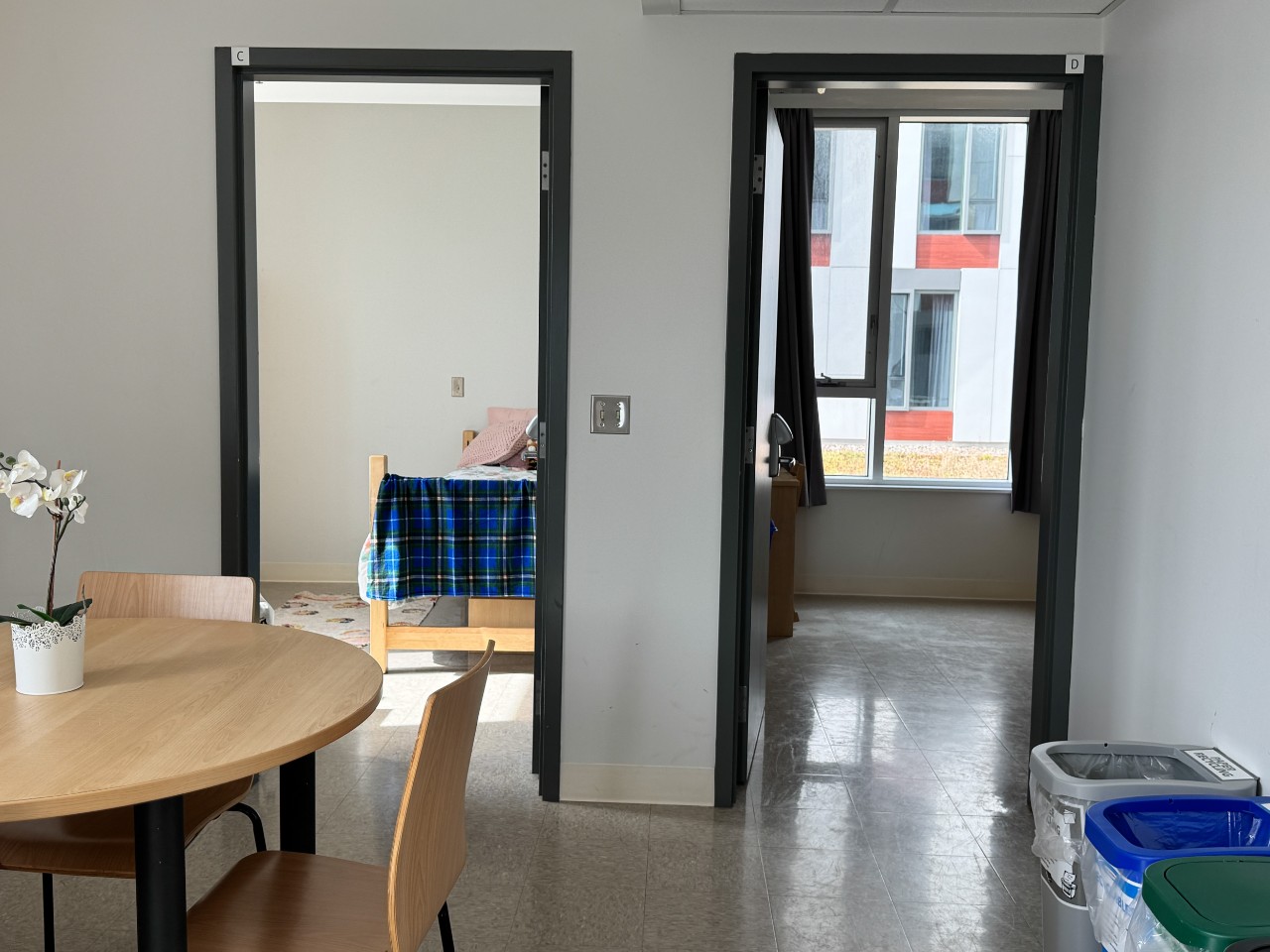 The bedroom doorways off the kitchen area in a 4-bedroom suite in LeMarchant Place