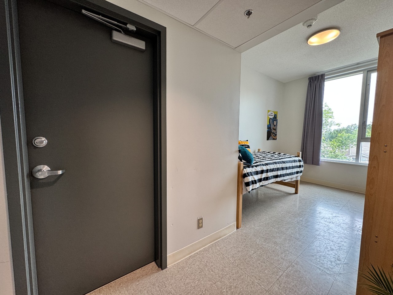 A single room with shared bath, showing the location of the bathroom door close to the entrance